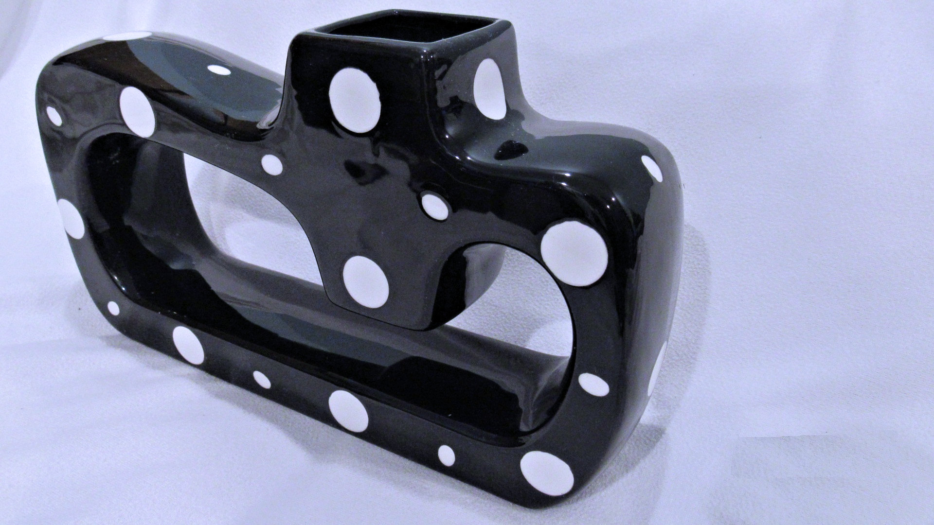 Black Ceramic Vase with White Polka Dots and Smooth Surface.